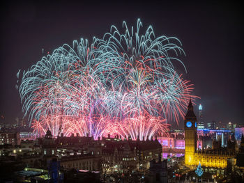 Low angle view of firework display at night