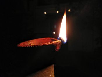 Close-up of illuminated lamp against black background