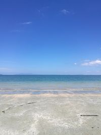 Scenic view of beach against blue sky