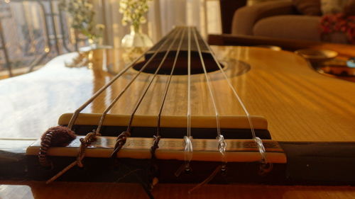 Close-up of guitar on table at home