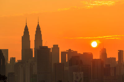 Modern buildings in city during sunset