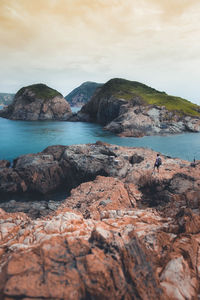 Scenic view of rocks in sea against sky