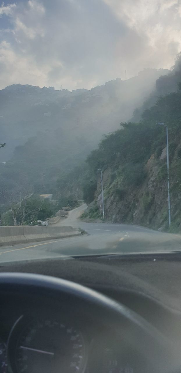 ROAD SEEN THROUGH WINDSHIELD OF CAR