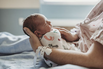 Side view of newborn boy profile with hat in hospital