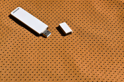 High angle view of usb stick on fabric