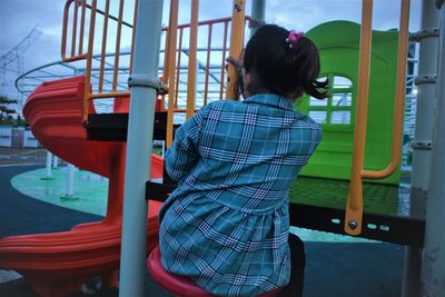 Rear view of woman in playground