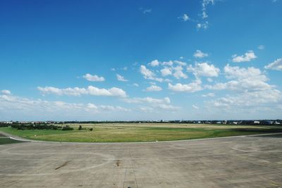 Scenic view of field against cloudy sky