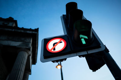 Low angle view of road sign against sky