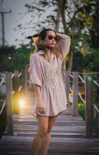 Portrait of young woman standing in city