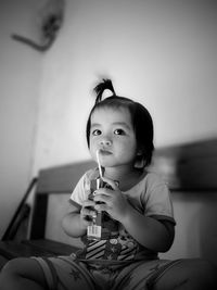Cute girl drinking drink at home