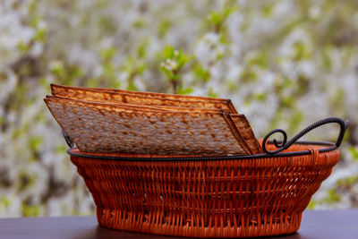 Close-up of crackers in wicker basket on table