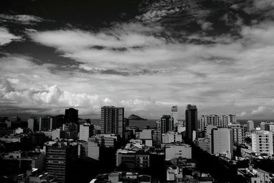 View of cityscape against cloudy sky