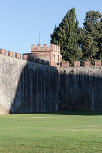 Built structure on field against clear sky