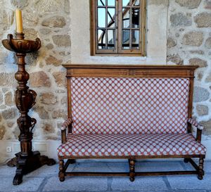 Empty chairs and table against window of old building