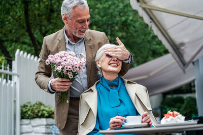 Portrait of a smiling young couple holding flower