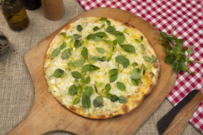 Brazilian pizza with cheese, mozzarella and basil, top view