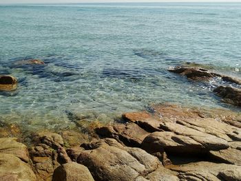 Scenic view of rocky coastline and clear water