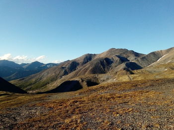 Scenic view of mountains against clear blue sky