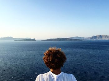 Rear view of man against sea