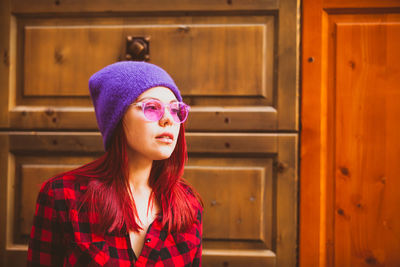 Portrait of young woman wearing hat