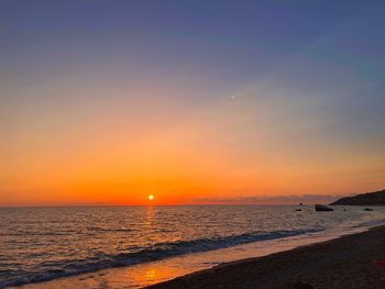 Scenic view of sea against clear sky during sunset