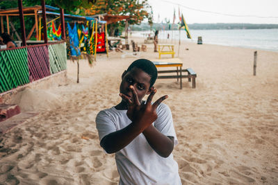 Portrait of boy holding sand on beach