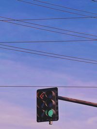 Low angle view of road sign against sky