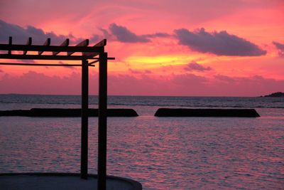 Scenic view of sea against romantic sky at sunset