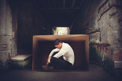 Man sitting in abandoned building