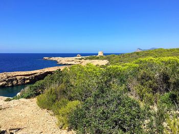 Scenic view of sea against clear blue sky