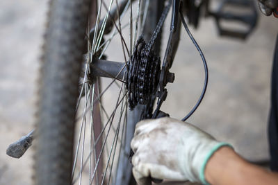 Close-up of hand holding bicycle