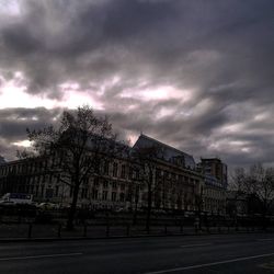 View of cityscape against cloudy sky