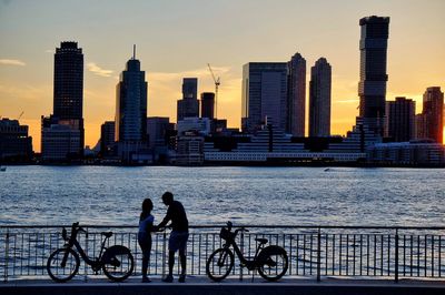 Silhouette of people on bridge at sea