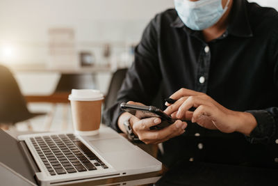 Midsection of woman using mobile phone