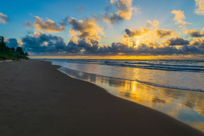 Scenic view of beach against sky during sunset