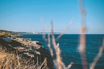 Scenic view of sea against clear blue sky