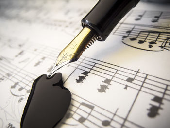 Fountain pen on notes sheet with inkblot.