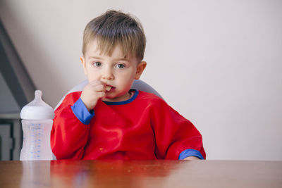 Portrait of cute boy at table