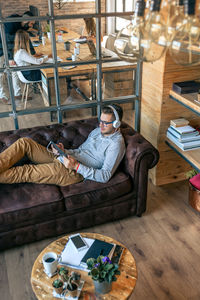 High angle view of man sitting at table