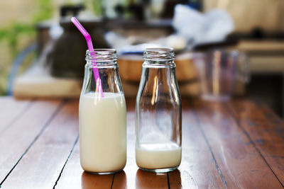 Close-up of milk bottles on table