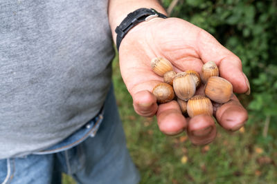 Midsection of man holding snail