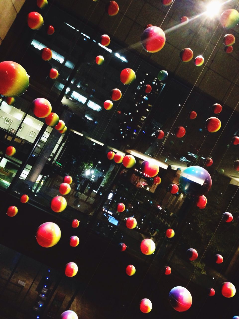 indoors, illuminated, multi colored, lighting equipment, low angle view, large group of objects, red, no people, decoration, ceiling, in a row, abundance, circle, high angle view, glass - material, close-up, celebration, light - natural phenomenon, pattern, technology