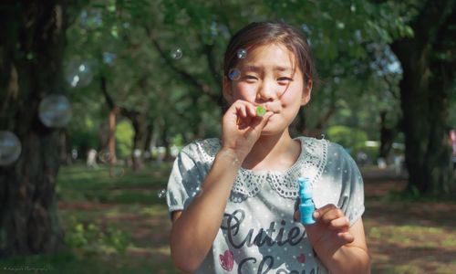 Portrait of smiling young woman in park