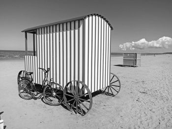 Bicycles on beach against sky