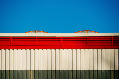 Multi colored built structure against blue sky