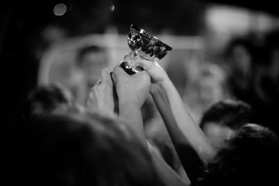 Sports team holding trophy at night