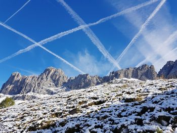 Scenic view of snowcapped mountains against blue sky