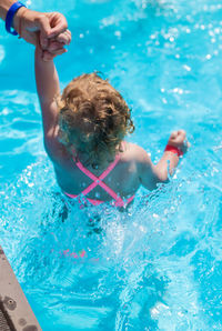 High angle view of boy swimming in pool