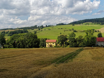 Poland mountains area. village houses in a wonderful green nature. behind the farming field.