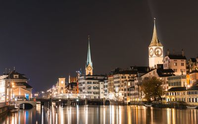 Reflection of illuminated buildings in city at night